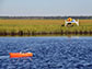 USGS scientist measures water and sediment movement at Forsythe National Wildlife Refuge