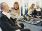 a man sitting in a chair getting his face made up