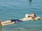 a student floating in the Dead Sea