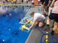 a student launches his team's ROV in the pool