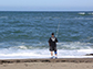 a man on the beach fishing