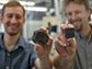 Theodore Them, left, holding an extinct fossil sample and Jeremy Owens, right, holding a rock core sample