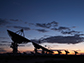 silhouettes of the Y-shaped Very Large Array working hard against a sunset in central New Mexico