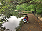 a student takes a sample of water from Lake Clara Meer to study bacteria