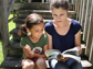 a woman and child looking at a book