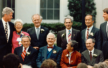 President Bill Clinton and a group of laureates