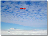 Photo of helicopter above iceberg