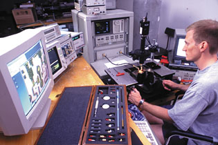 Students perform scanning electron microscopy (SEM) on a photodetector chip in a Nanolab.